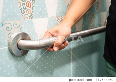 Asian elderly woman use toilet bathroom handle security, healthy strong medical concept. Asian elderly woman use toilet bathroom handle security, healthy strong medical concept. 117388260