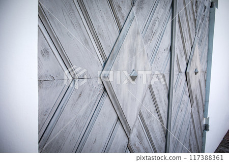 Gray wooden door with rhombus decor, an architectural element Gray wooden door with rhombus decor, an architectural element 117388361