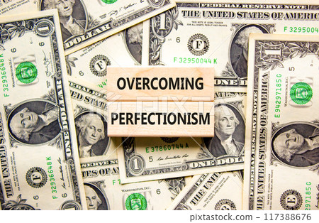Overcoming perfectionism symbol. Concept words Overcoming perfectionism on beautiful wooden block. Beautiful dollar bills background. Dollar bills. Business Overcoming perfectionism concept Copy space Overcoming perfectionism symbol. Concept words Overcoming perfectionism on beautiful wooden block. Beautiful dollar bills background. Dollar bills. Business Overcoming perfectionism concept Copy space 117388676