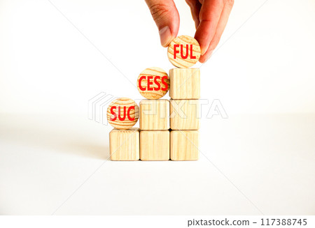 Successful symbol. Concept word Successful on beautiful wooden circles. Businessman hand. Beautiful white background. Business successful concept. Copy space. 117388745