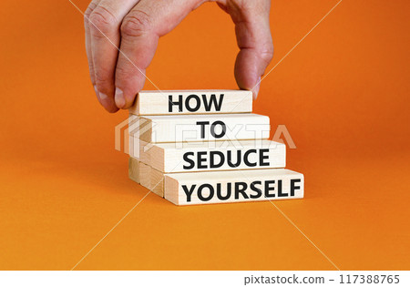 How to seduce yourself symbol. Concept word How to seduce yourself on wooden blocks. Businessman hand. Beautiful orange table orange background. Business and how to seduce yourself concept. Copy space 117388765