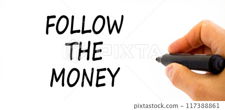 Follow the money symbol. Concept words Follow the money on beautiful white paper. Beautiful white table white background. Businessman hand. Business and follow the money concept. Copy space. 117388861