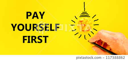 Pay yourself first symbol. Concept words Pay yourself first on beautiful yellow paper. Beautiful yellow background. Light bulb icon. Businessman hand. Business pay yourself first concept. Copy space. 117388862