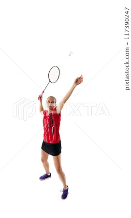 Dynamic photo of young woman, badminton player serving shuttlecock, throwing it up against white studio background. Dynamic photo of young woman, badminton player serving shuttlecock, throwing it up against white studio background. 117390247