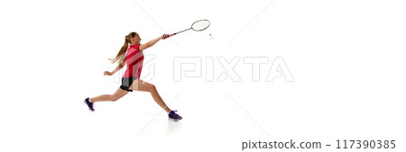 Banner. Young sporty woman playing badminton, leaping to hit shuttlecock in motion against white background with negative space. 117390385