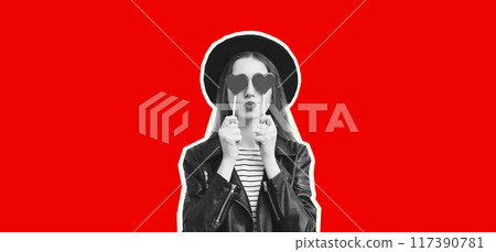 Portrait of stylish young woman with heart shaped lollipop posing in black hat on red background Portrait of stylish young woman with heart shaped lollipop posing in black hat on red background 117390781