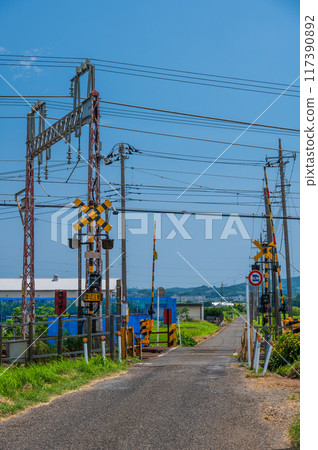 A railroad crossing in the countryside of Isehara 117390892