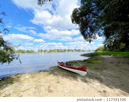 Boat floating on the beach 117391306