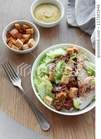 A bowl  of  Caesar salad 117391648