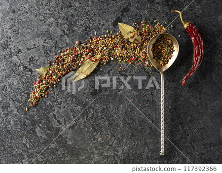 Mix of organic dried spices on a black stone background. 117392366