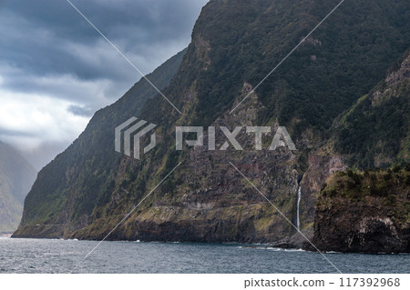 Rocky coast with a waterfall near the town of Seixal on the island of Madeira Rocky coast with a waterfall near the town of Seixal on the island of Madeira 117392968