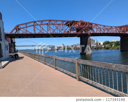 Portland, Oregon, USA - 07.10.2024: View of the Broadway Bridge and Fremont Bridge across the Willamette River. Portland, Oregon, USA. Portland, Oregon, USA - 07.10.2024: View of the Broadway Bridge and Fremont Bridge across the Willamette River. Portland, Oregon, USA. 117393198