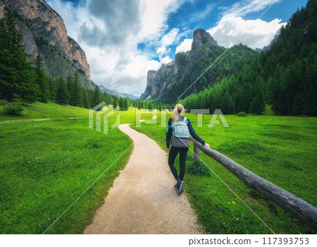 Woman with backpack on the trail in beautiful mountain valley 117393753