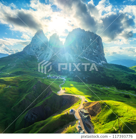 Aerial view of road in alpine mountains at sunset in summer Aerial view of road in alpine mountains at sunset in summer 117393776