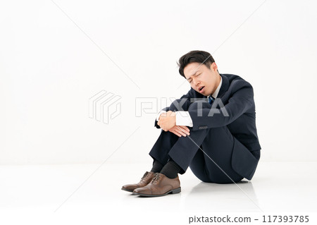 商人坐在健身房裡，感到沮喪 117393785