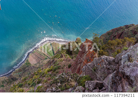 View of the ocean and coastline from the glass-floored Cabo Girao lookout on Madeira Island View of the ocean and coastline from the glass-floored Cabo Girao lookout on Madeira Island 117394211