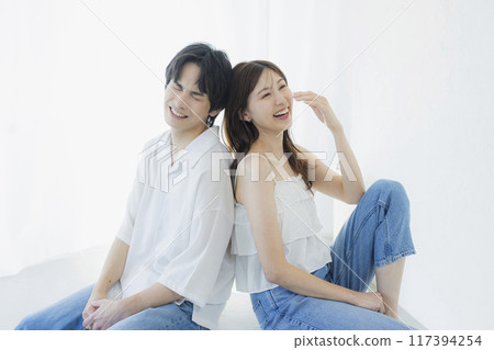 A couple wearing matching denim outfits 117394254