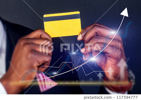 A man holding a credit card with a black stripe and a yellow stripe 117394777