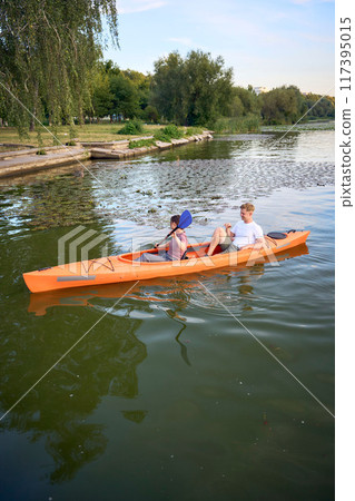 the couple in love kayaking on the river at sunset the couple in love kayaking on the river at sunset 117395015