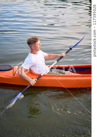 the couple in love kayaking on the river at sunset 117395026