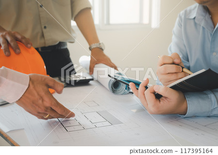 Confident team of architect working together in a office.Then discussing about new startup project on desk. Architect discuss with engineer about project in office, architectural concept. Confident team of architect working together in a office.Then discussing about new startup project on desk. Architect discuss with engineer about project in office, architectural concept. 117395164