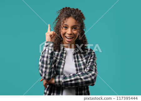 Genius creative idea, african teenager girl - eureka moment, pointing finger up 117395444