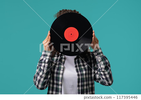 Young funny teenager girl with vinyl record disc. Hobby, Music Lover, Collection 117395446