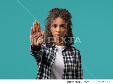 Uninterested african woman disapproving with NO sign gesture. Denying, rejecting 117395447
