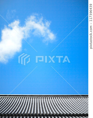 Temple roof tiles and blue sky 117396439