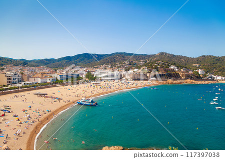 Sandy beach drenched in sun. Ideal for travel and tourism content. 117397038