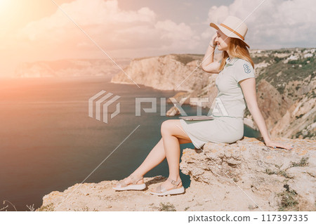 Woman Enjoying the View on a Cliffside with Laptop 117397335