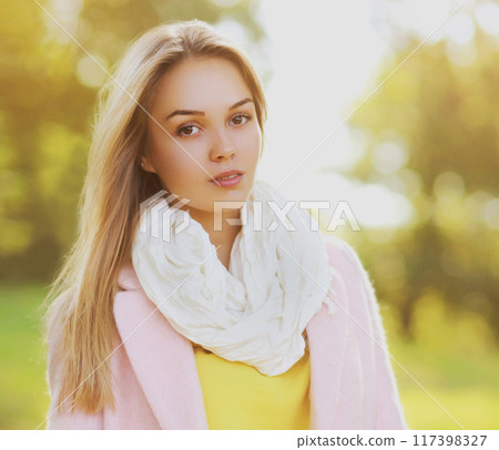 Portrait of beautiful blonde young woman looking at camera outdoors Portrait of beautiful blonde young woman looking at camera outdoors 117398327