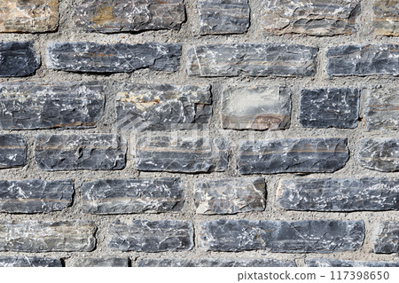 A close up background of grey natural stone wall. High quality photo 117398650