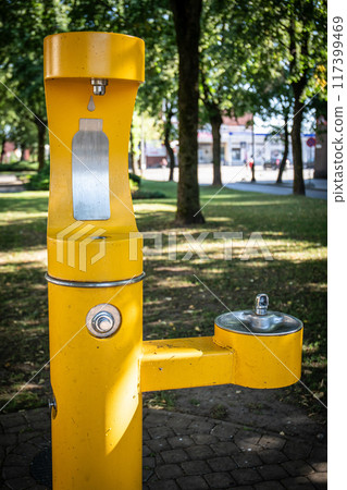 Yellow potable water station in an urban environment, well-being and infrastructure Yellow potable water station in an urban environment, well-being and infrastructure 117399469