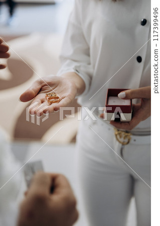 Exchanging wedding rings in a beautiful ceremony, symbolizing love, commitment, and union Exchanging wedding rings in a beautiful ceremony, symbolizing love, commitment, and union 117399496
