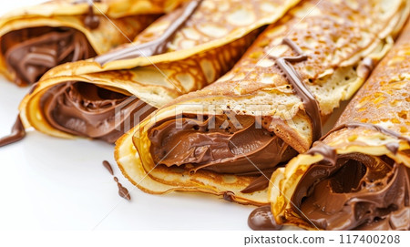Rolled crepes filled with chocolate spread. 117400208