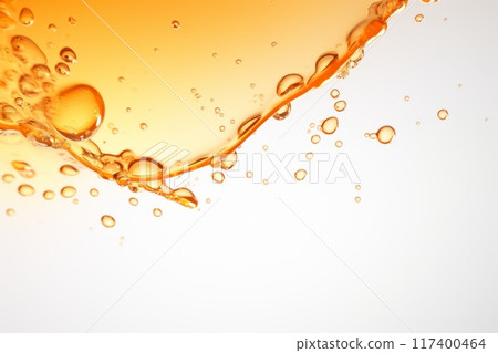 Orange liquid splash with bubbles and drops. 117400464