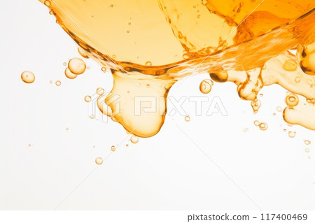 Orange liquid splash with bubbles and drops. 117400469