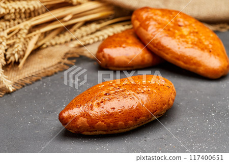 Golden-brown baked pies, perfect for a savory or sweet treat, ideal for any time of the day Golden-brown baked pies, perfect for a savory or sweet treat, ideal for any time of the day 117400651