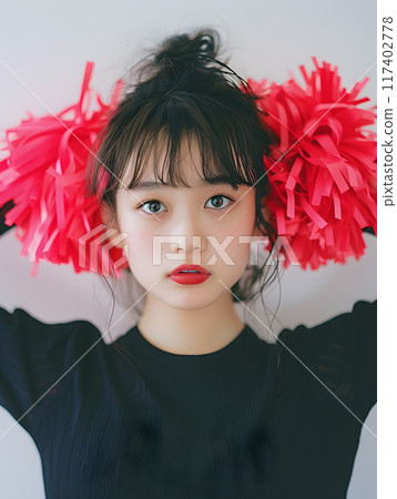 Cheerful Asian cheerleader woman with an energetic glow 117402778