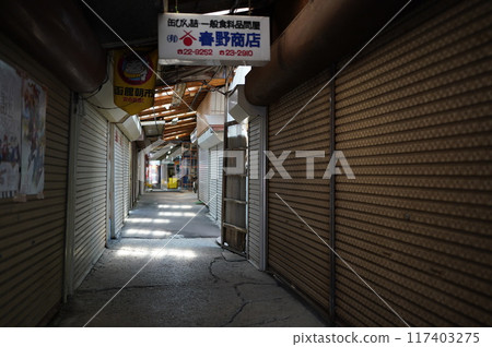 Hakodate Market: Light shines through the quiet shopping street with its shutters closed Hakodate Market: Light shines through the quiet shopping street with its shutters closed 117403275