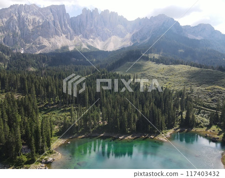 Stunning Mountain Landscape Featuring a Serene Lake Surrounded by Karersee, Carezza lake, is a lake in the Dolomites in South Tyrol, Italy 117403432