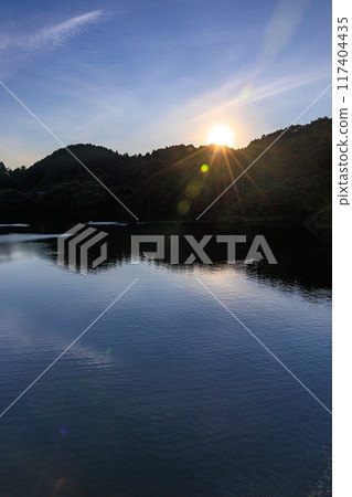 奈良市東部佈目水壩的夏季 水壩湖的夜景 夕陽照耀著對岸的水壩湖水面①。 117404435