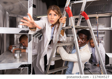 Young woman solving puzzles in quest room 117404527