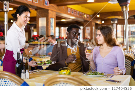 Man and woman having dinner in restaurant Man and woman having dinner in restaurant 117404536