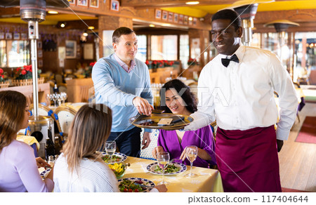 African American waiter brought mobile phones on the tray of restaurant African American waiter brought mobile phones on the tray of restaurant 117404644