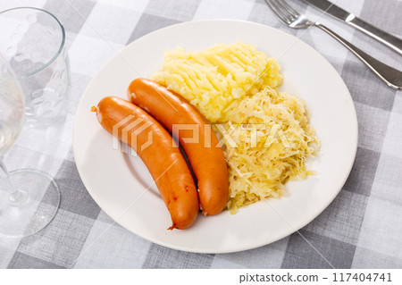 Fried sausages with mashed potato slices and stewed cabbage Fried sausages with mashed potato slices and stewed cabbage 117404741