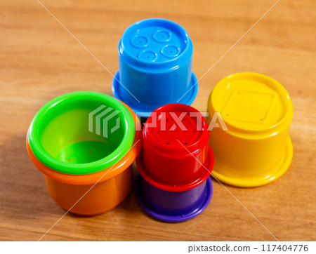 Childrens toy plastic cup pyramid made of multicolored elements Childrens toy plastic cup pyramid made of multicolored elements 117404776