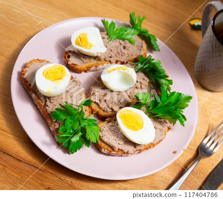 Sandwiches with pollock liver and roe pate, eggs, and greens 117404786
