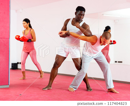 Sparring of two men at self-defense training in sports club 117404823